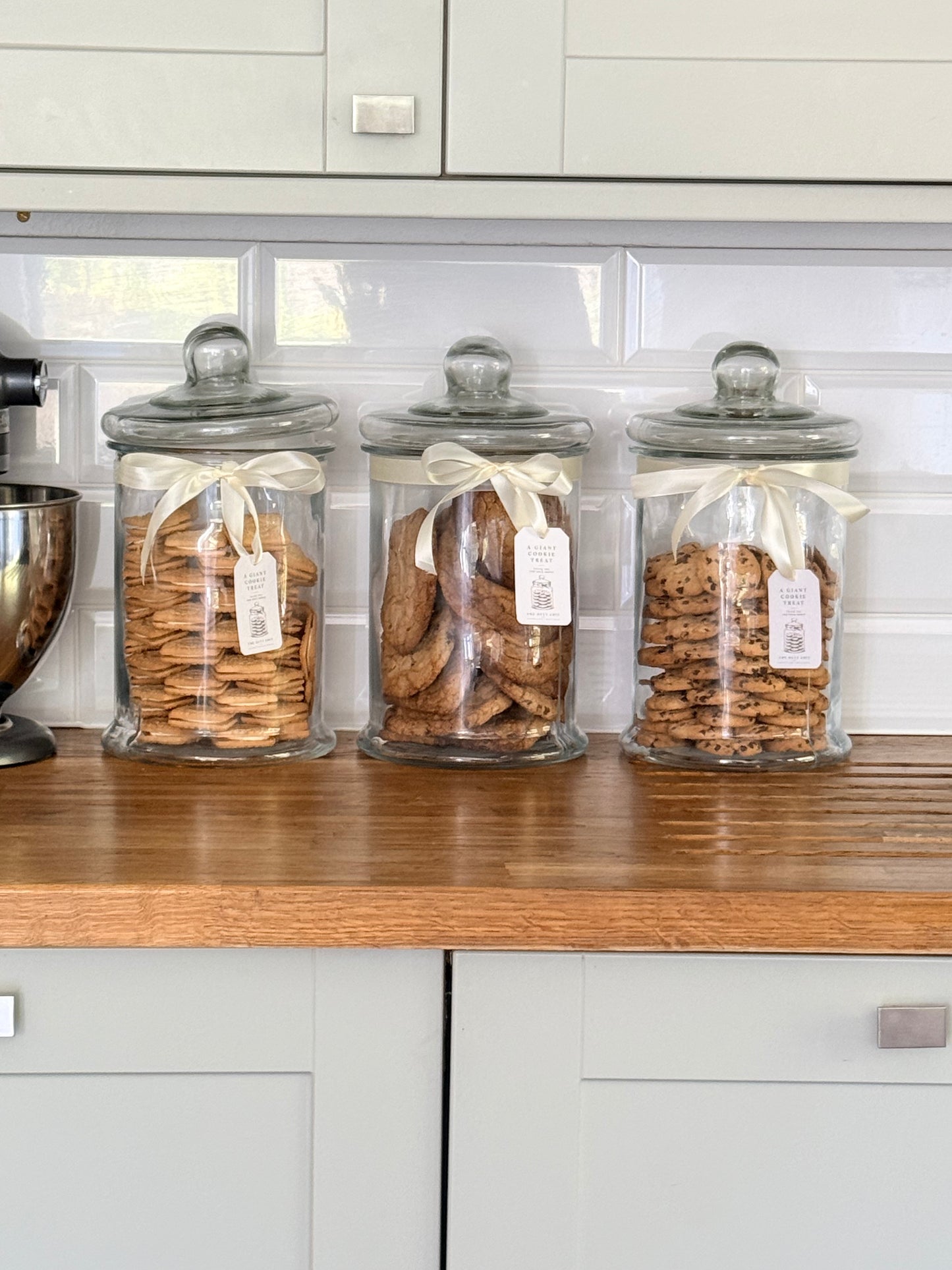 Cookie jars filled aesthetically with different kind of cookies and biscuits